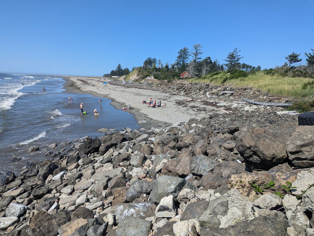 a rocky beach with people swimming (MyCoast AI)