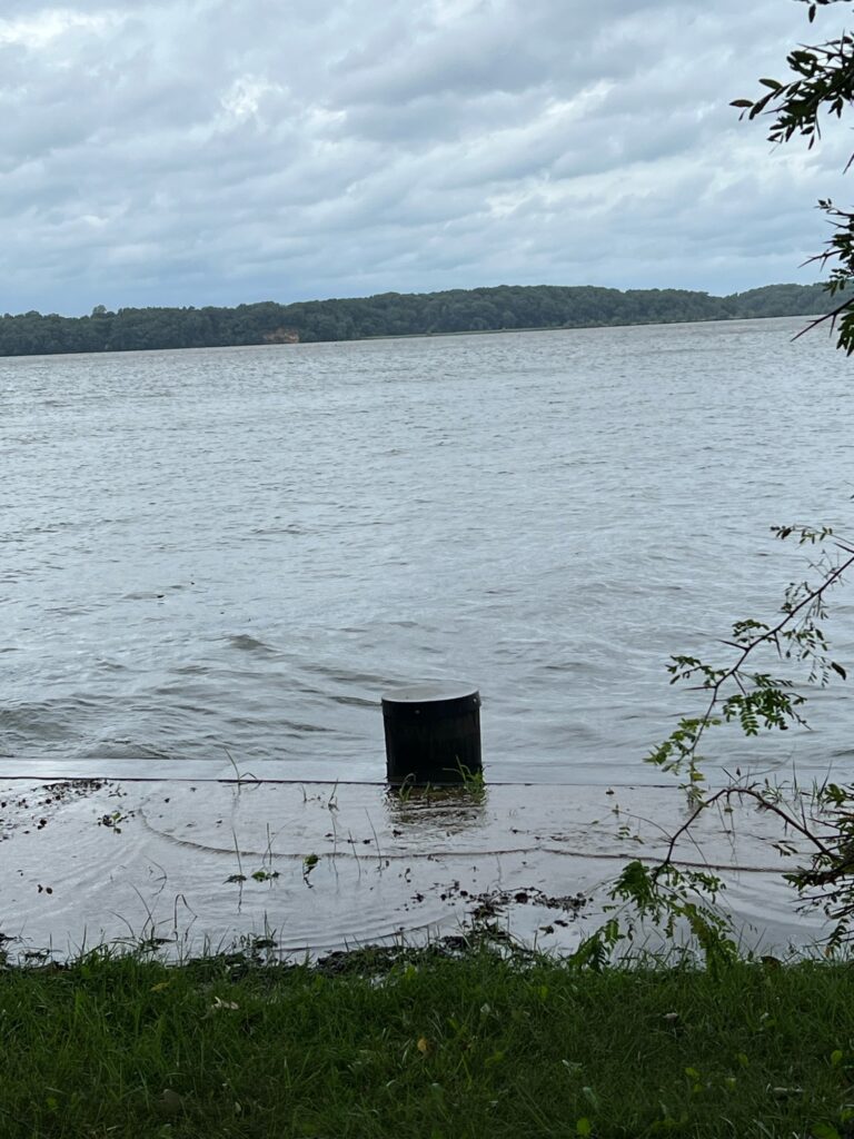 a small wooden structure in the middle of a lake (MyCoast AI)