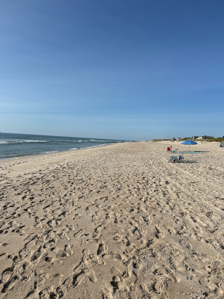 a sandy beach with chairs and umbrellas (MyCoast AI)