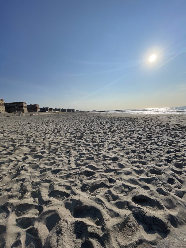 a sandy beach with buildings in the background (MyCoast AI)