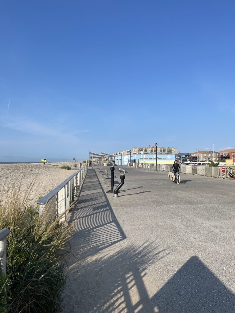 a person riding a bicycle on a path by a body of water (MyCoast AI)