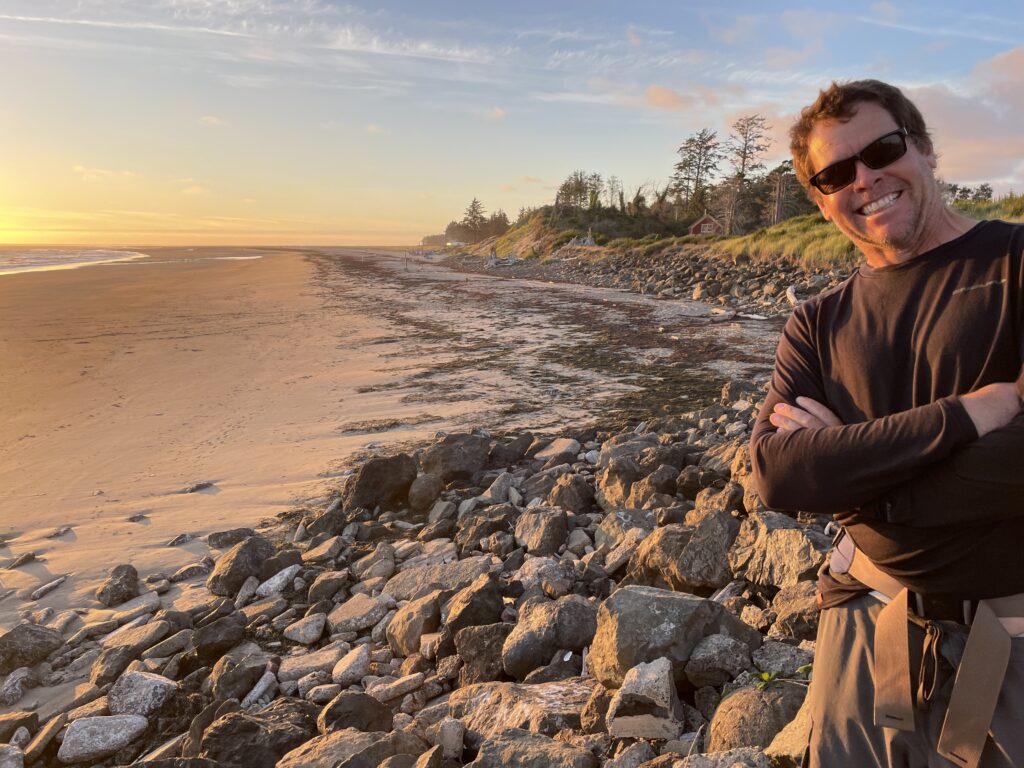 a man standing on a rocky beach (MyCoast AI)
