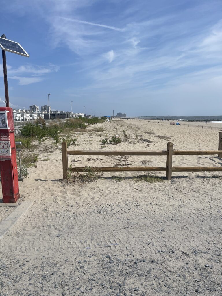 a wooden fence on a beach (MyCoast AI)