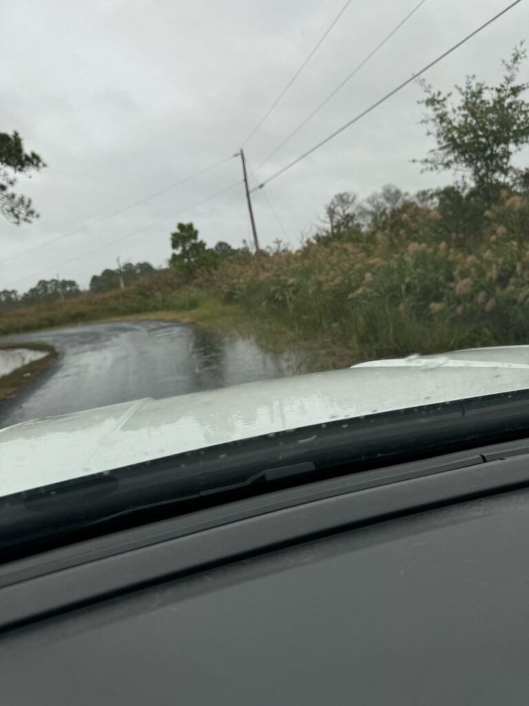 a car driving on a wet road (MyCoast AI)