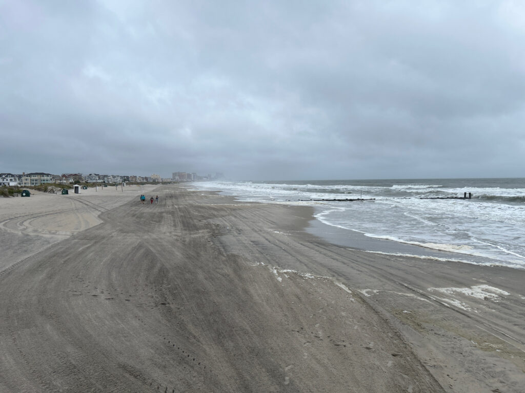 a sandy beach with waves crashing on it (MyCoast AI)