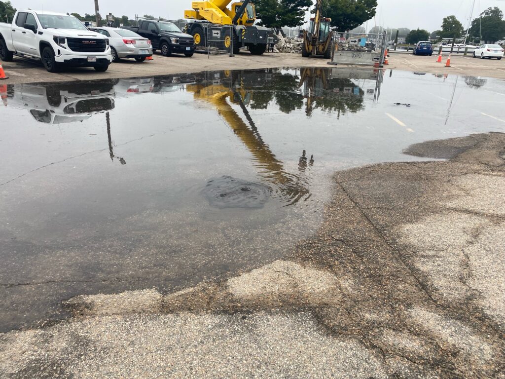 a puddle of water on the street (MyCoast AI)