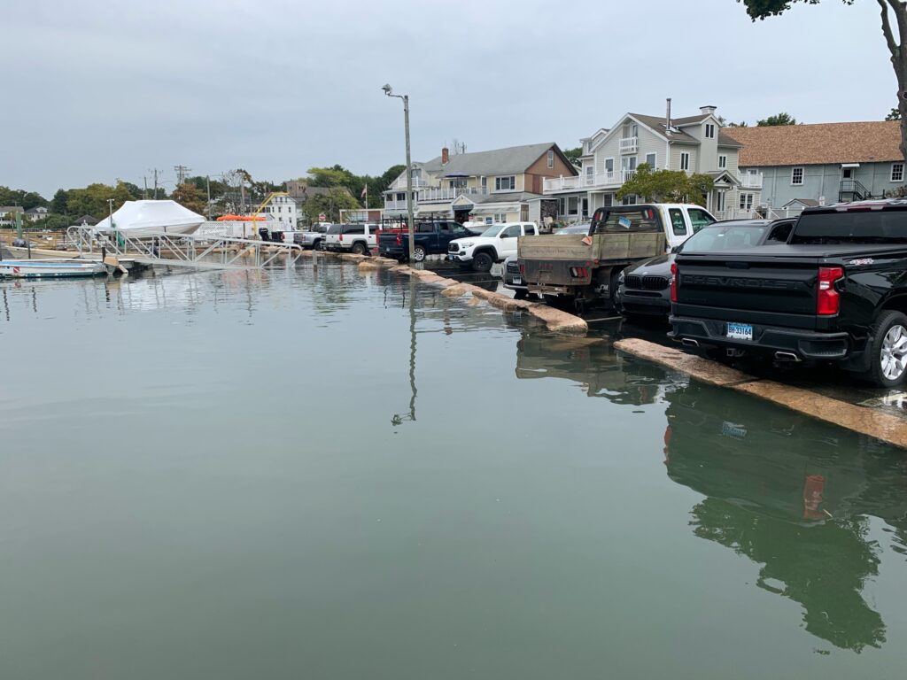a flooded street with cars and houses (MyCoast AI)