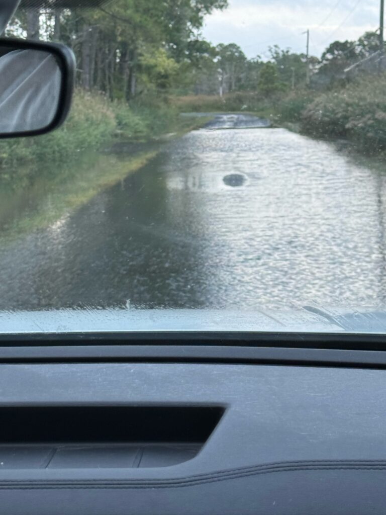 a car driving on a wet road (MyCoast AI)