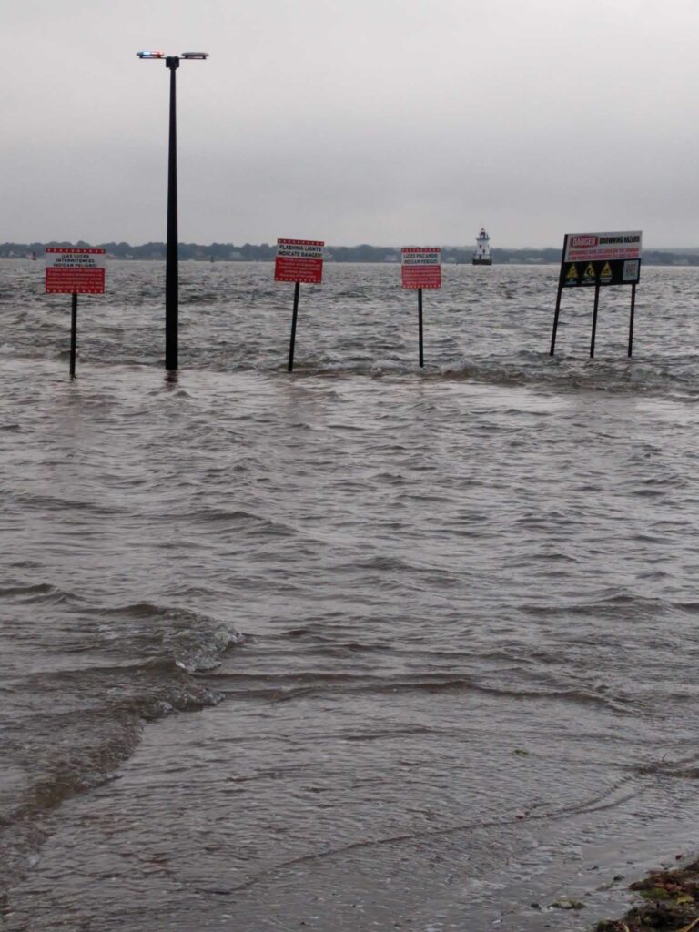 a flooded road with signs (MyCoast AI)