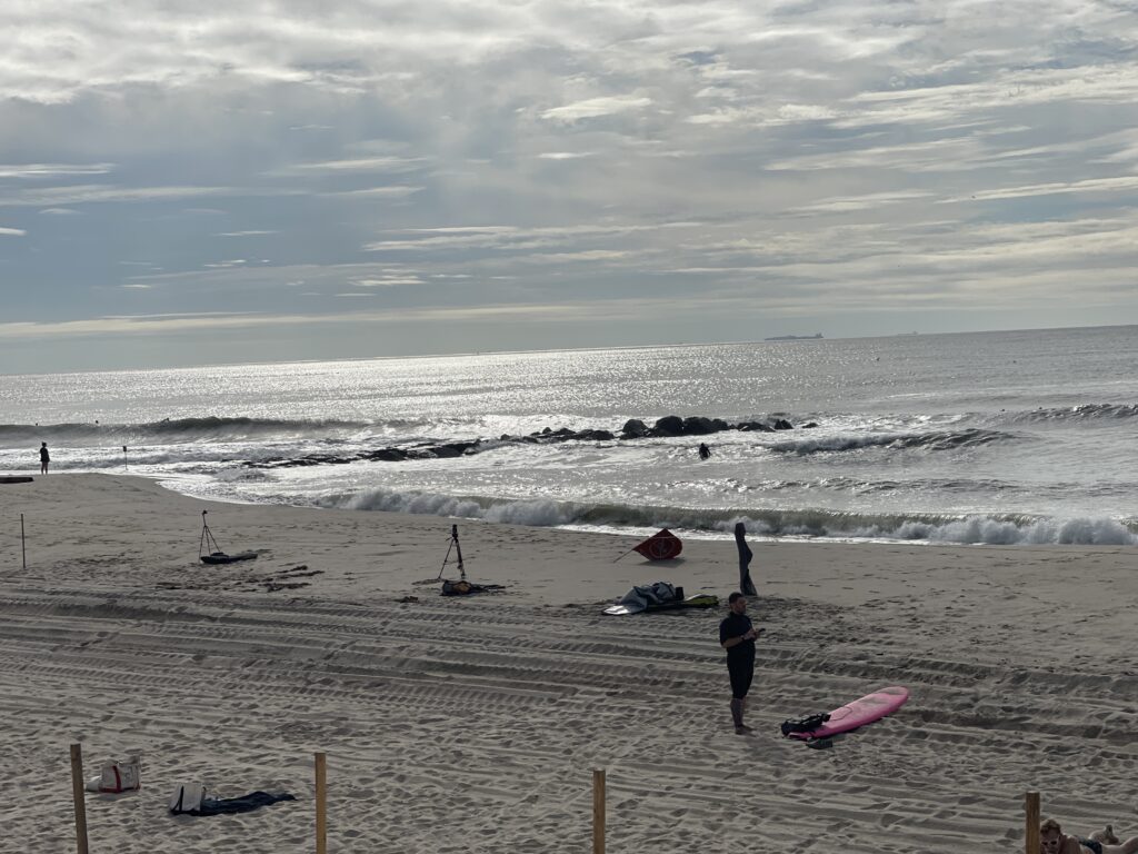 a group of people stand on a beach (MyCoast AI)