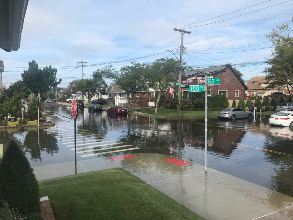 a flooded street with cars and people (MyCoast AI)