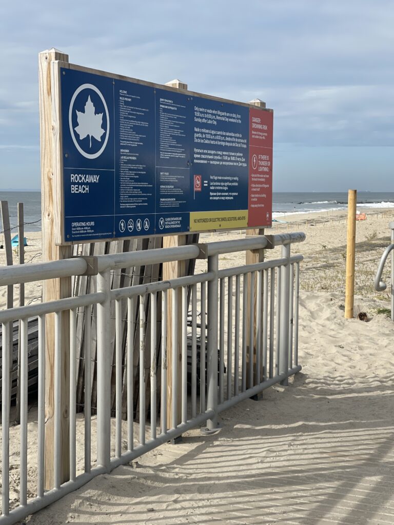a sign on a beach (MyCoast AI)