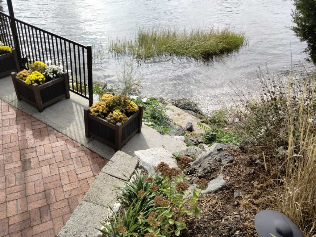 a patio with a railing and a body of water in the background (MyCoast AI)