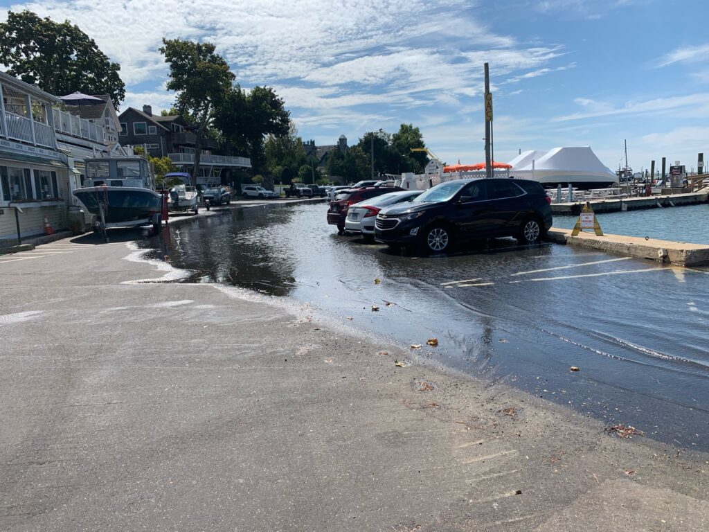 a flooded street with cars parked on the side (MyCoast AI)