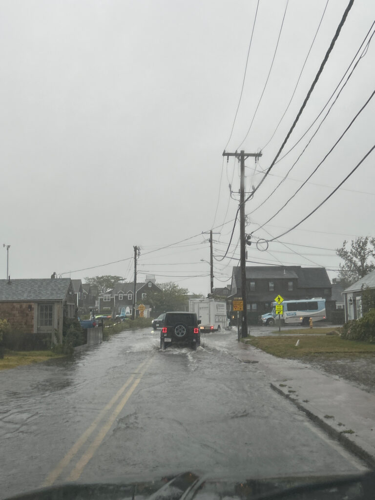 a car driving down a wet road (MyCoast AI)