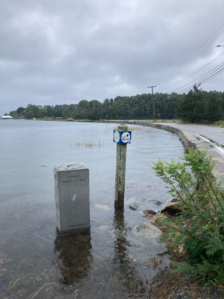 a flooded road with a sign (MyCoast AI)