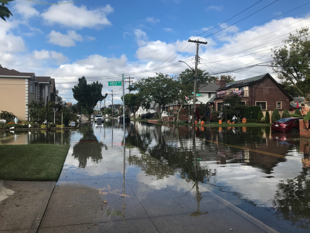 a flooded street with buildings and cars (MyCoast AI)