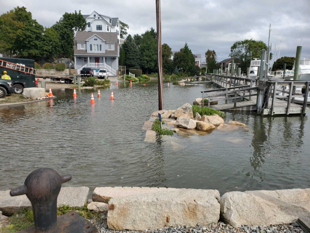 a body of water with a dock and a house in the background (MyCoast AI)