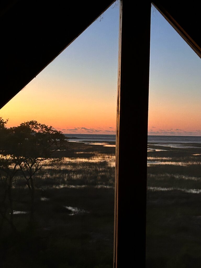 a view of a sunset through a window (MyCoast AI)