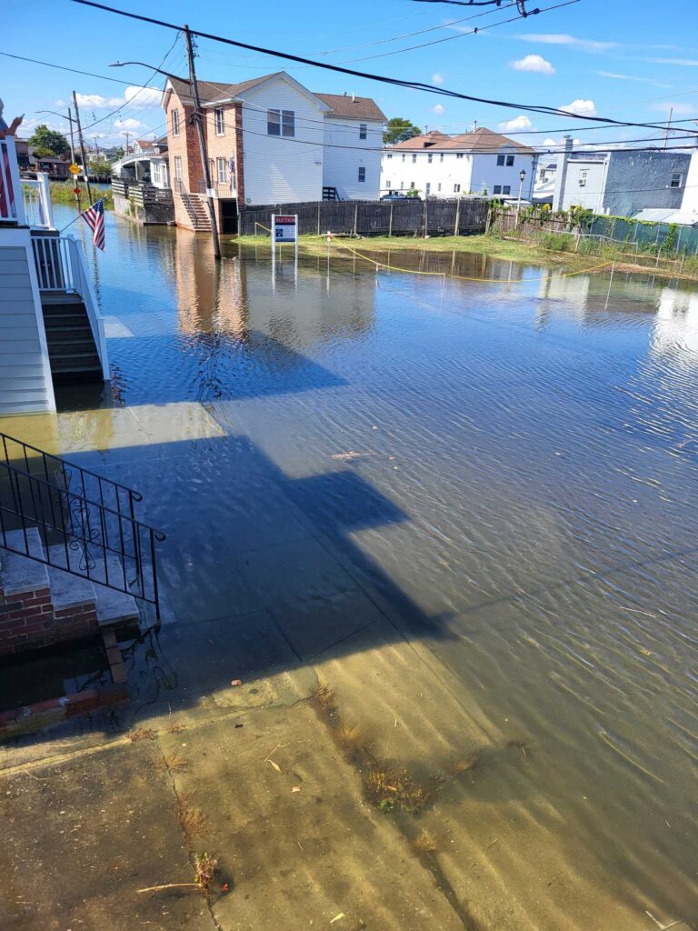a flooded street with buildings on either side of it (MyCoast AI)