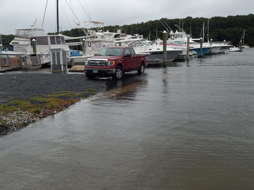 a red car parked on the side of a river (MyCoast AI)