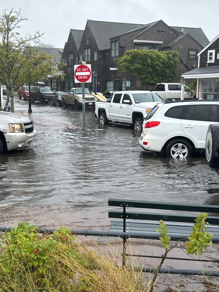 a flooded street with cars and a stop sign (MyCoast AI)