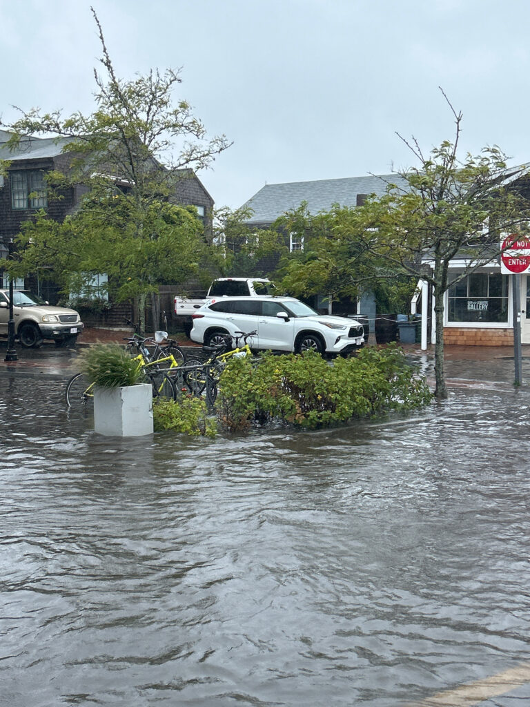 a flooded street with cars and buildings (MyCoast AI)