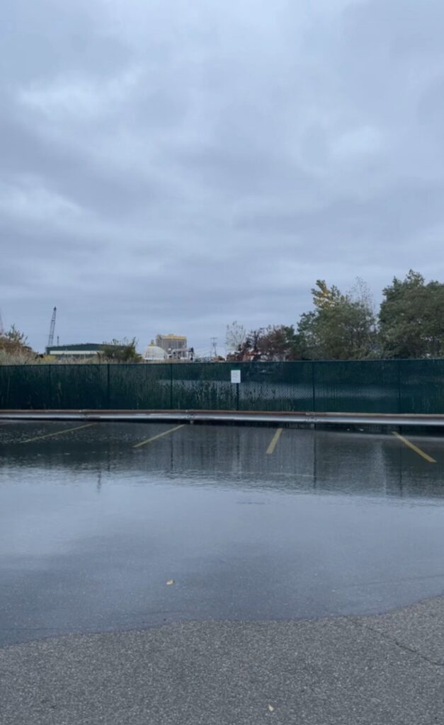 a body of water with a fence and trees around it (MyCoast AI)