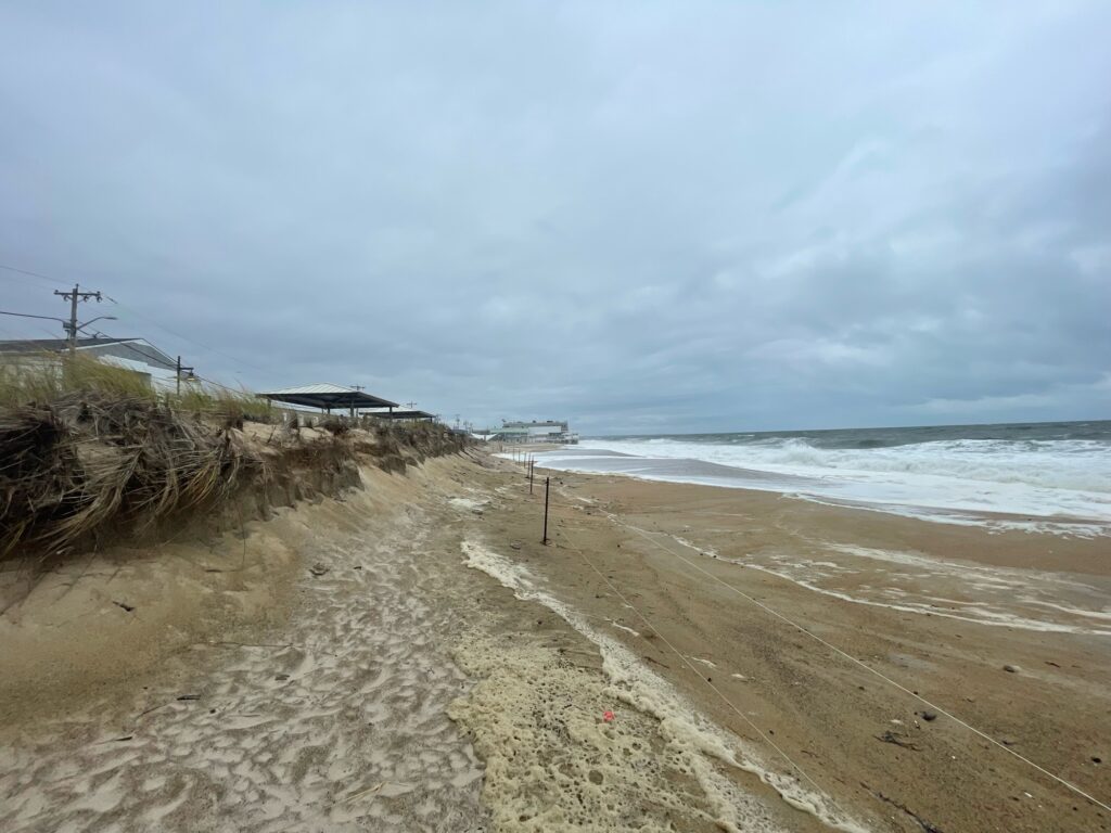 a sandy beach with a house on the shore (MyCoast AI)