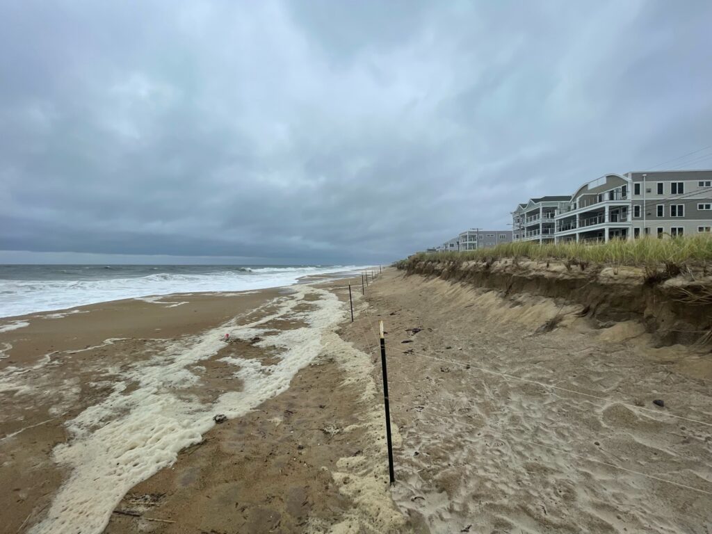 a sandy beach with buildings in the background (MyCoast AI)
