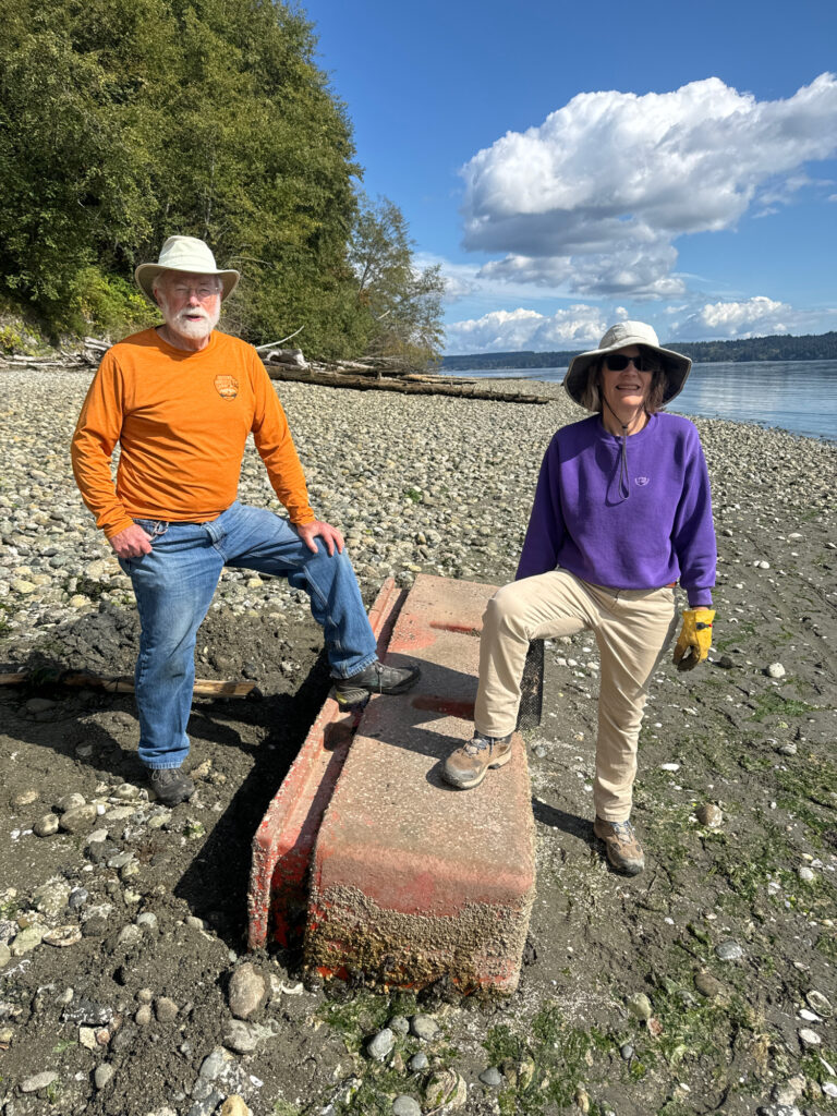 a man and woman sitting on a bench by a body of water (MyCoast AI)