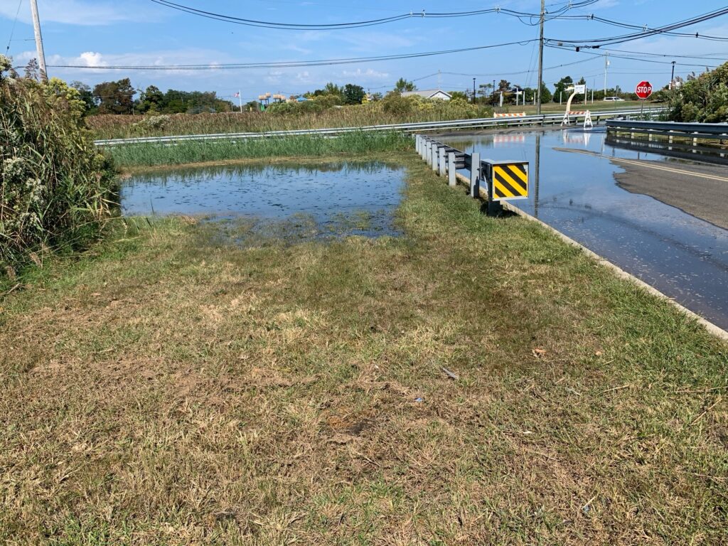 a flooded road with a sign (MyCoast AI)