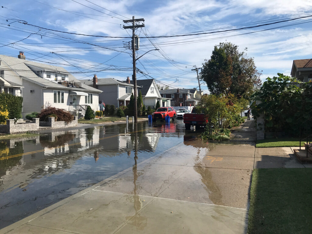 a flooded street with cars parked on the side (MyCoast AI)