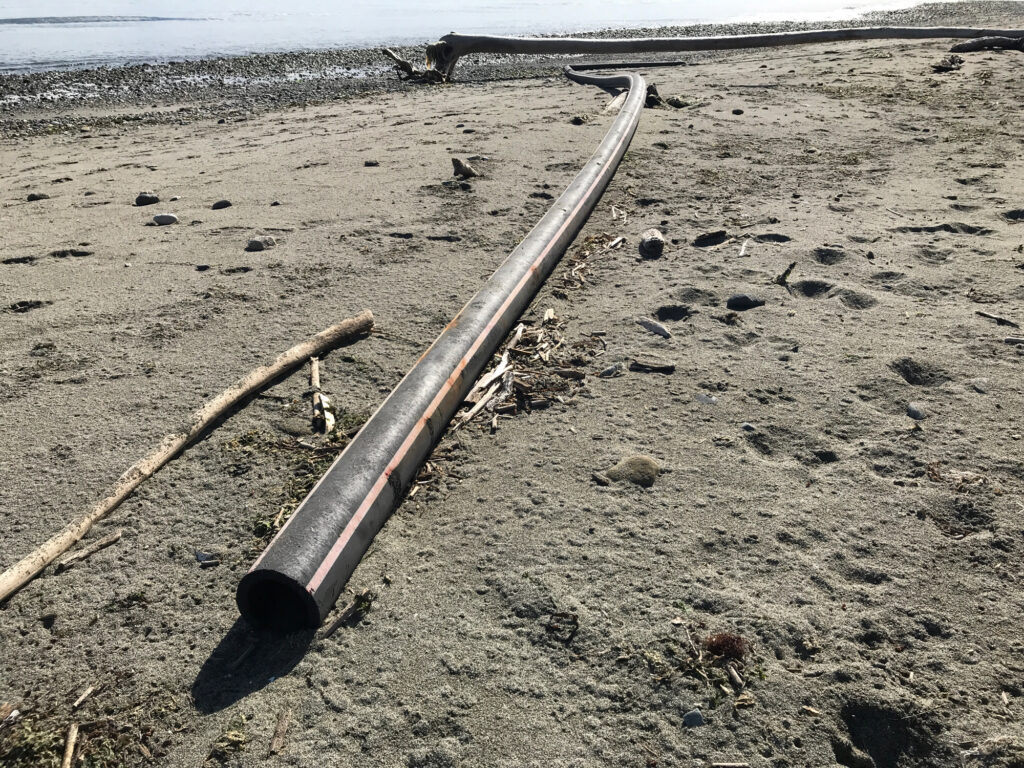 a large metal object on a beach (MyCoast AI)