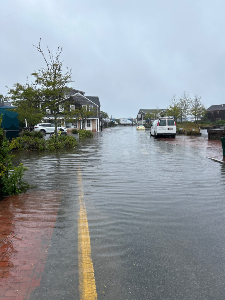 a flooded street with cars and houses (MyCoast AI)