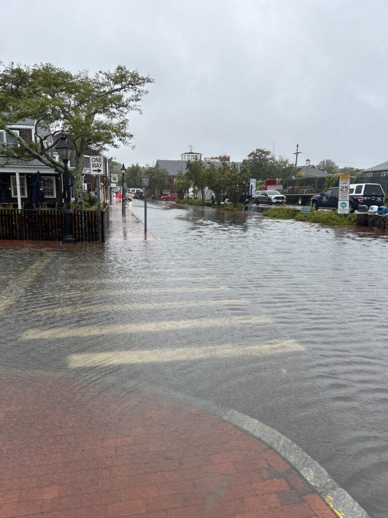 a flooded street with cars parked on the side (MyCoast AI)