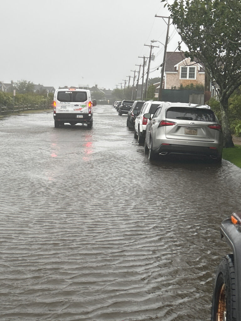 a flooded street with cars parked on the side (MyCoast AI)