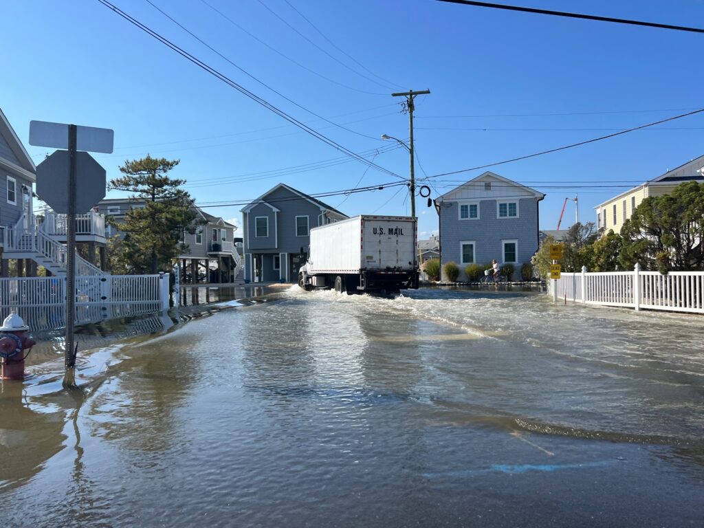 a flooded street with houses and power lines (MyCoast AI)