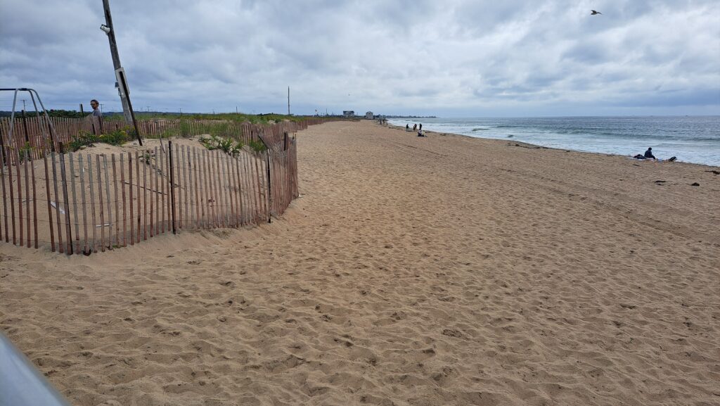 a sandy beach with a fence (MyCoast AI)