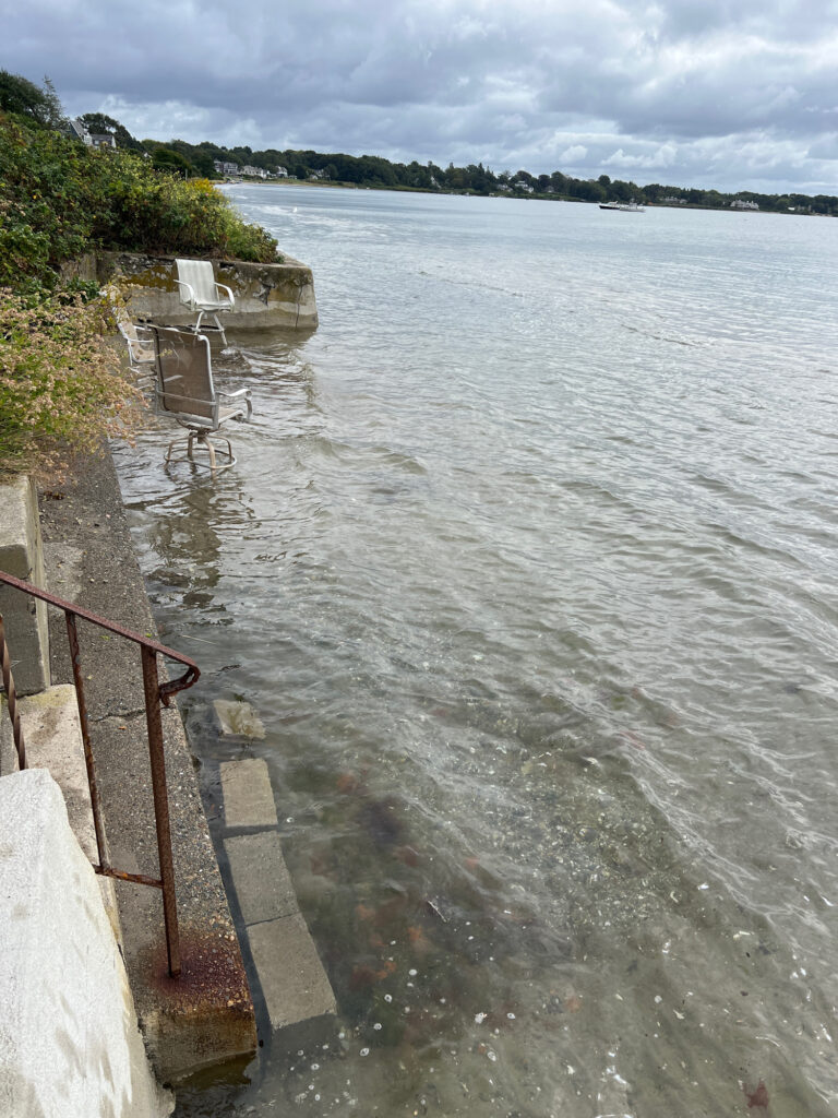 a body of water with a dock and a chair on it (MyCoast AI)