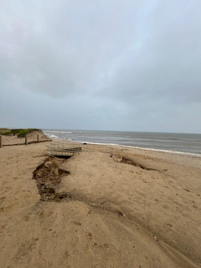 a sandy beach with a pier (MyCoast AI)