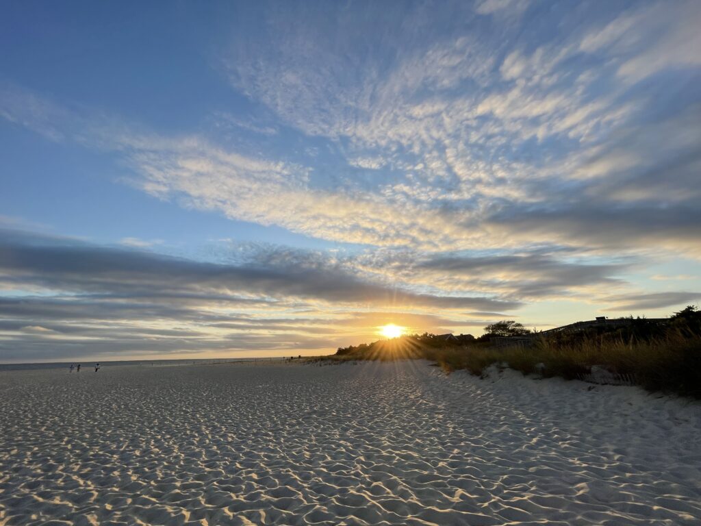 a beach with the sun setting (MyCoast AI)