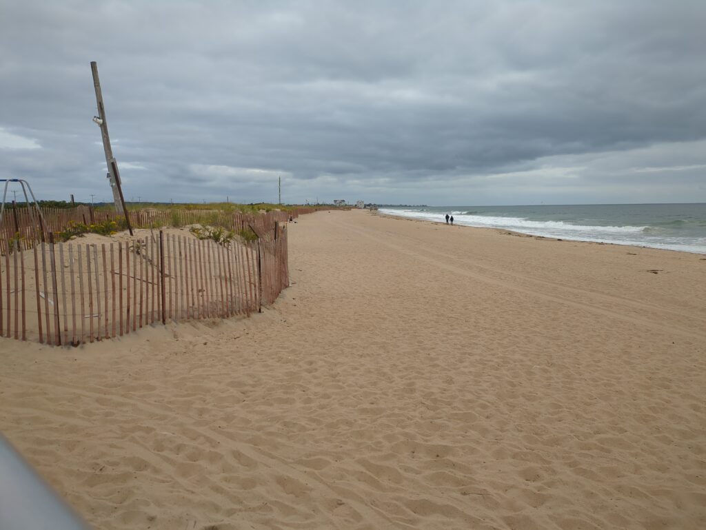 a sandy beach with a fence (MyCoast AI)