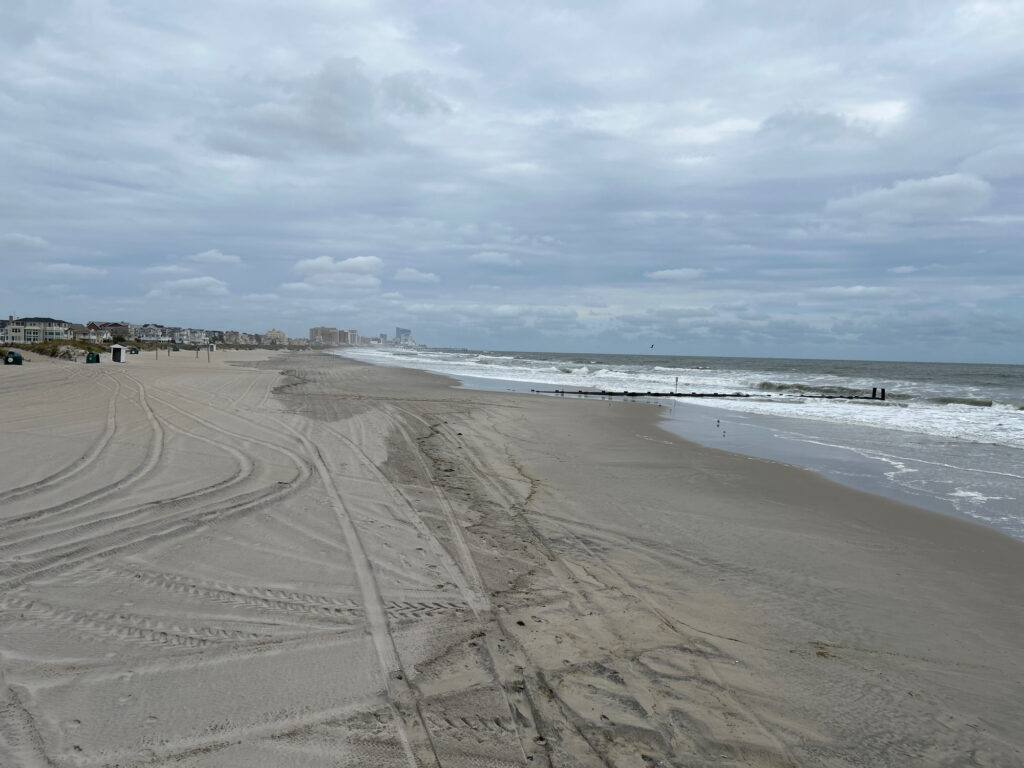 a sandy beach with waves crashing on it (MyCoast AI)
