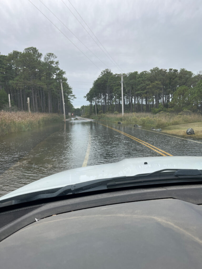 a flooded road with trees on either side of it (MyCoast AI)
