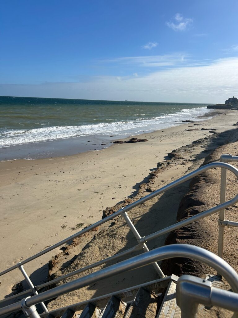 a metal railing on a beach (MyCoast AI)