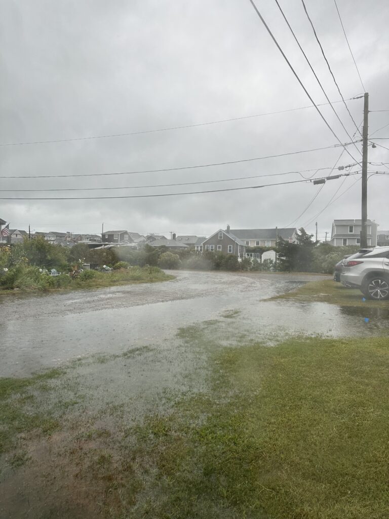 a flooded street with houses and power lines (MyCoast AI)