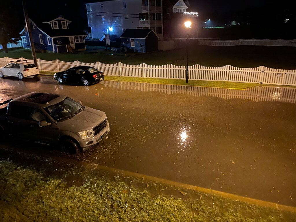 a group of cars driving on a wet road at night (MyCoast AI)