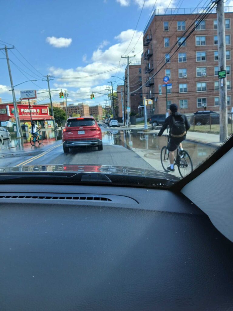 a person riding a bicycle on a city street (MyCoast AI)