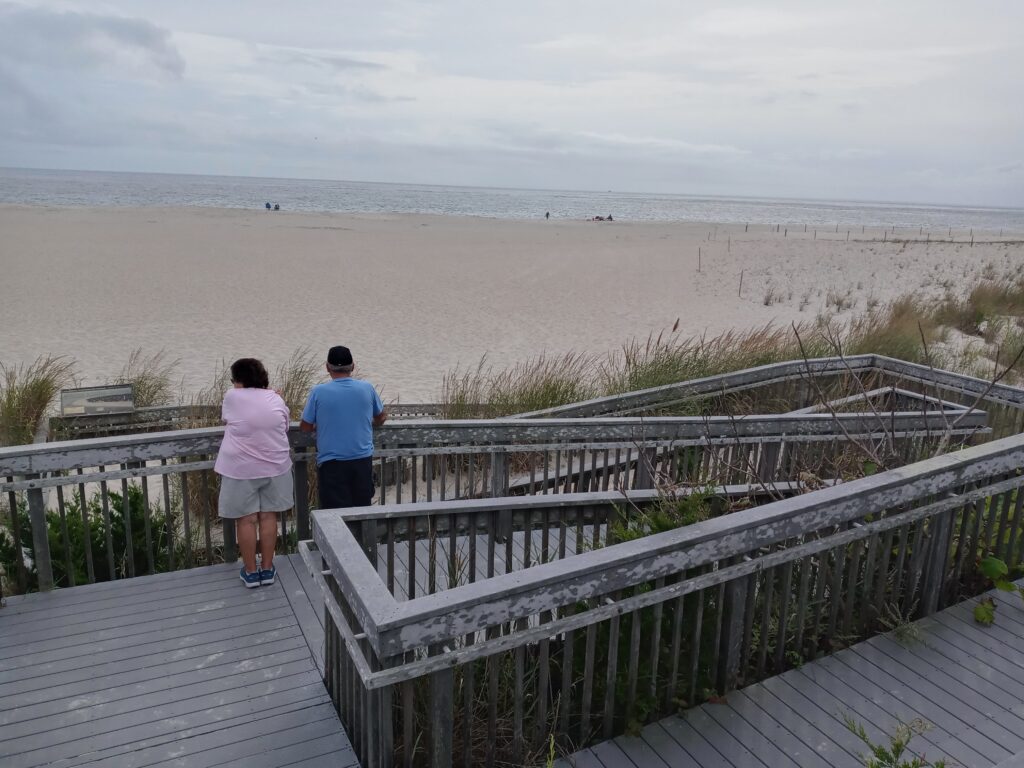 a couple walking on a boardwalk (MyCoast AI)